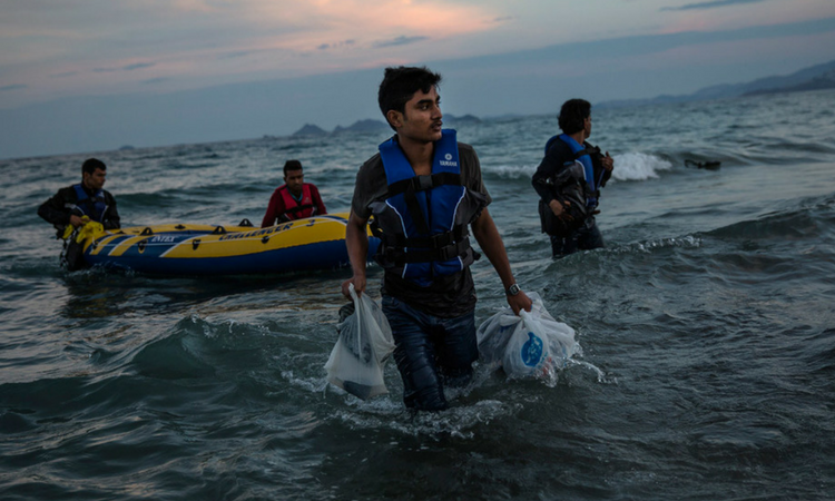 male refugees floating in by boat